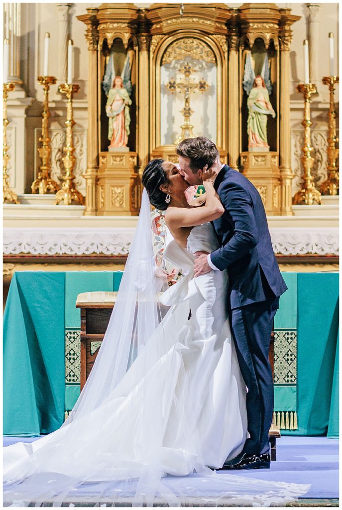 Bride and groom share first kiss for Kayla Bouren Photography