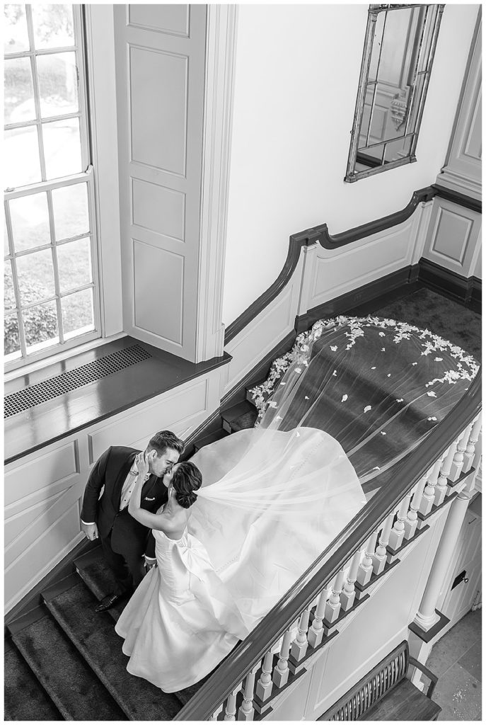 Husband and wife kiss down stairwell for Michigan Photographer