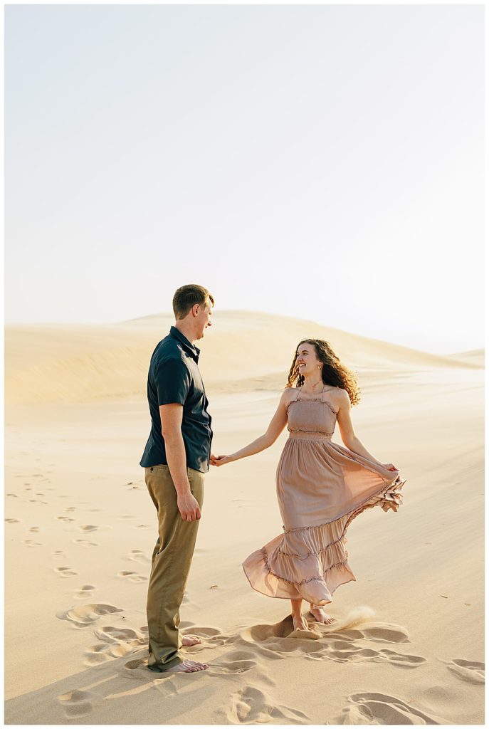 Woman and man dancing in Silver Lakes Sand Dunes Engagement Session.