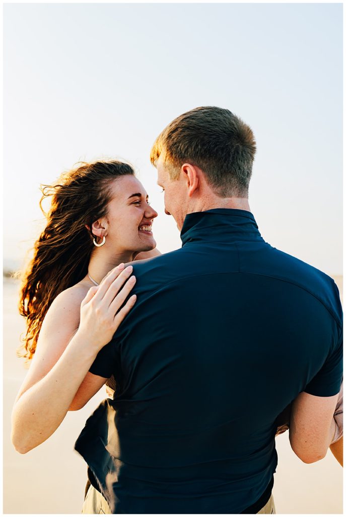 Couple share a smile by Kayla Bouren Photography.