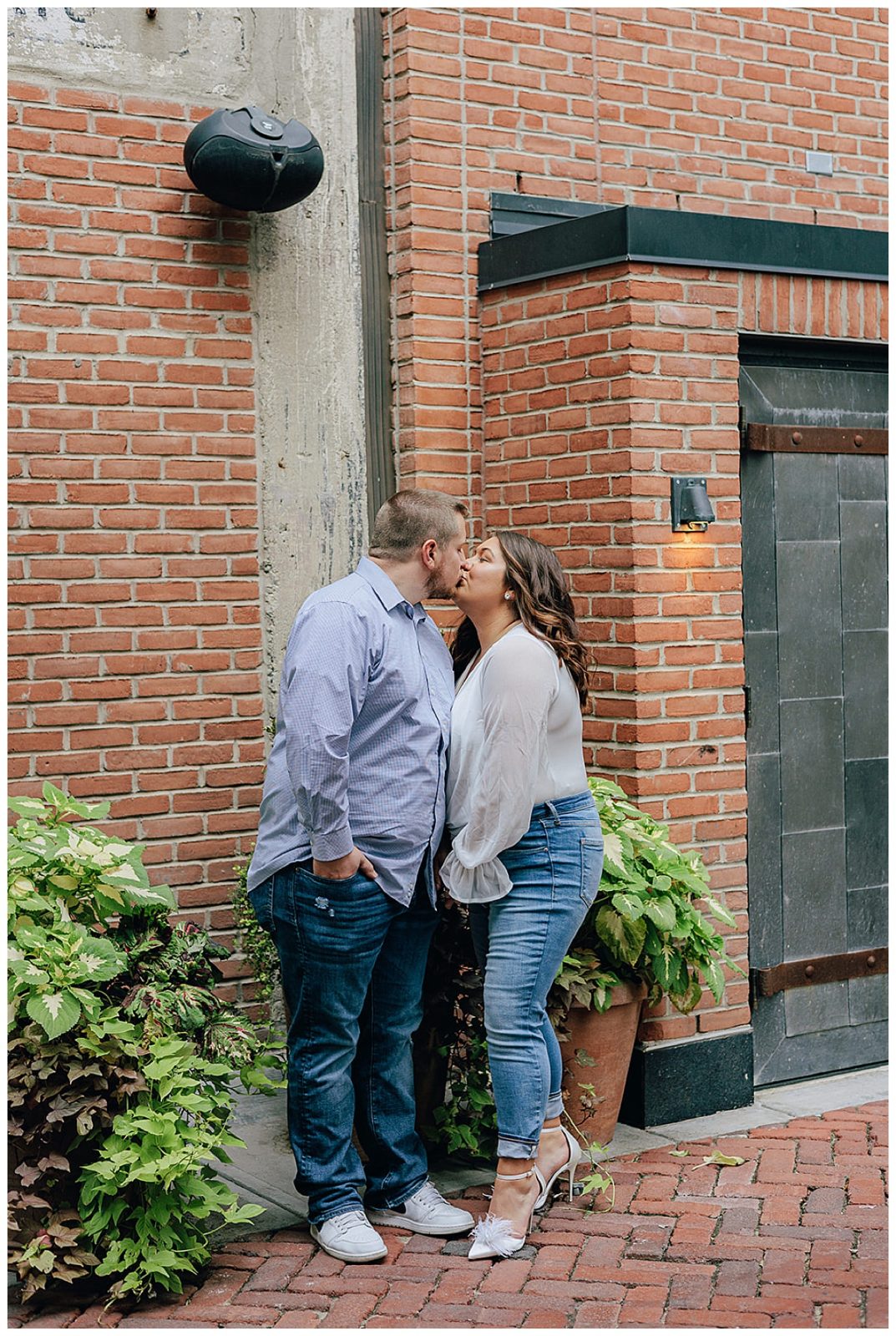 Future married couple kiss for Downtown Engagement Session