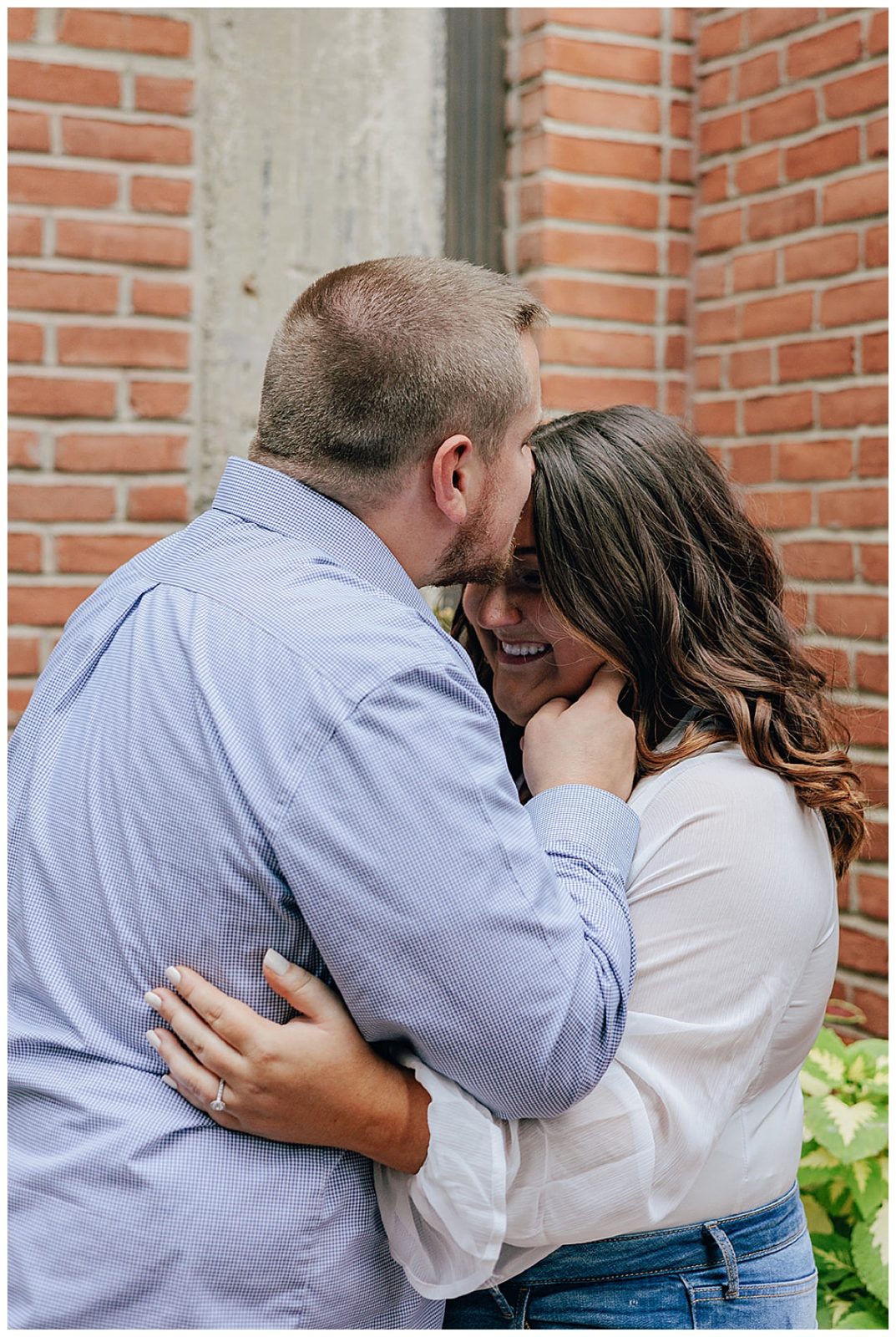 Future husband kisses future wife on forehead for Kayla Bouren Photography
