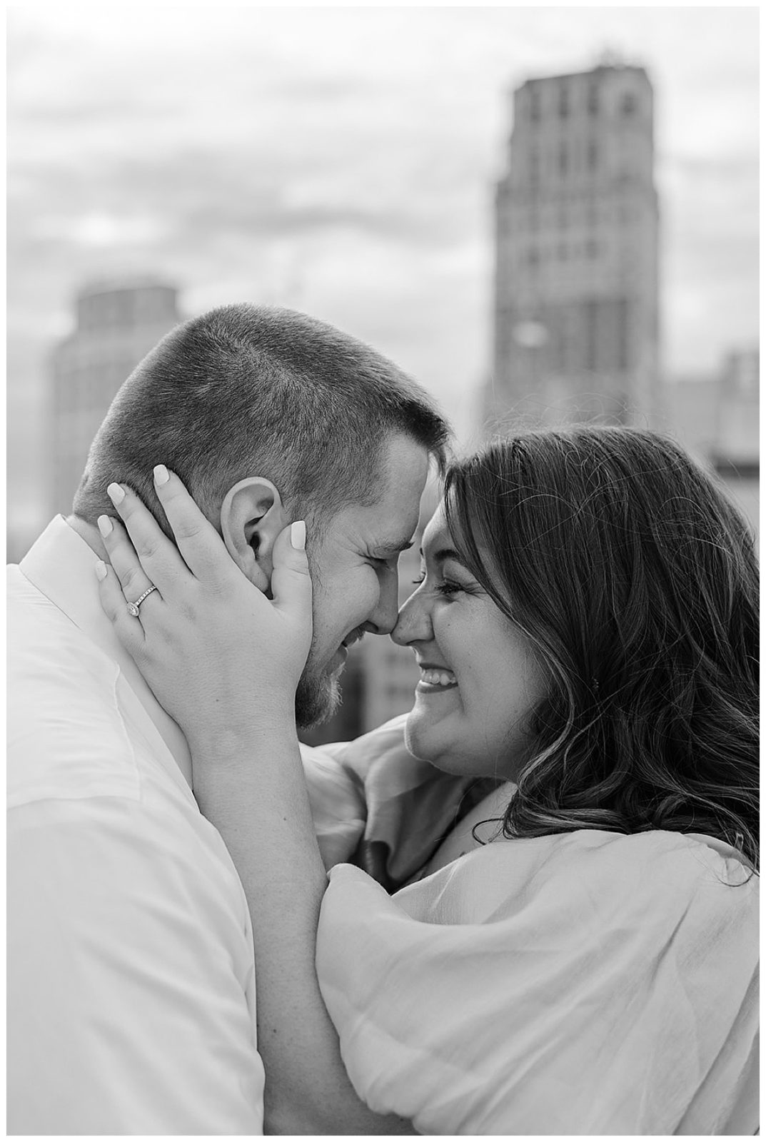 Soon to be husband and wife holding each other close Downtown Engagement Session