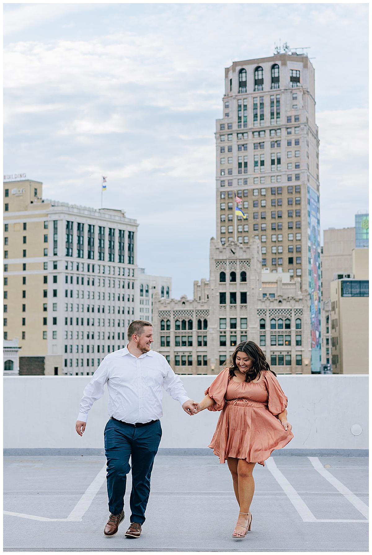 Lady and guy walk hand in hand for Downtown Engagement Session