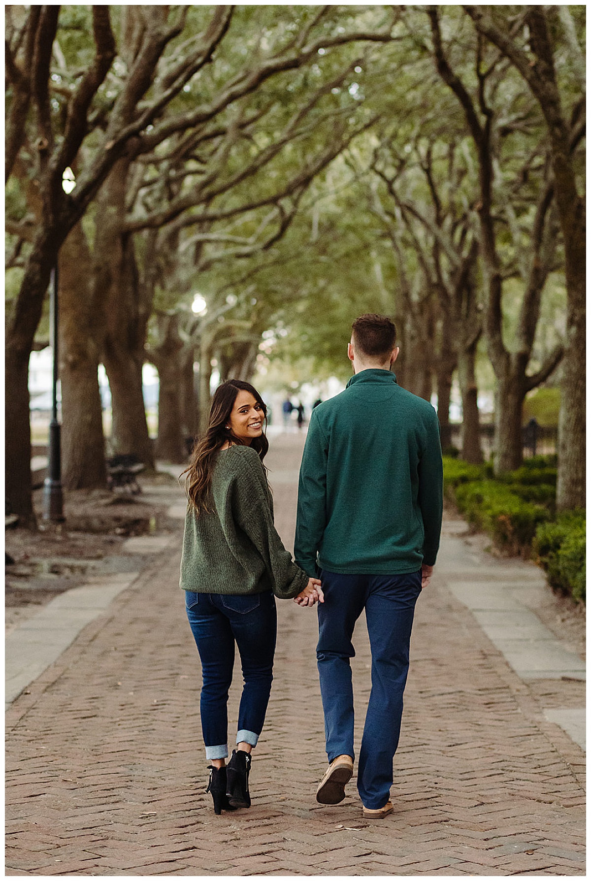 Engaged couple walking down street for Kayla Bouren Photography