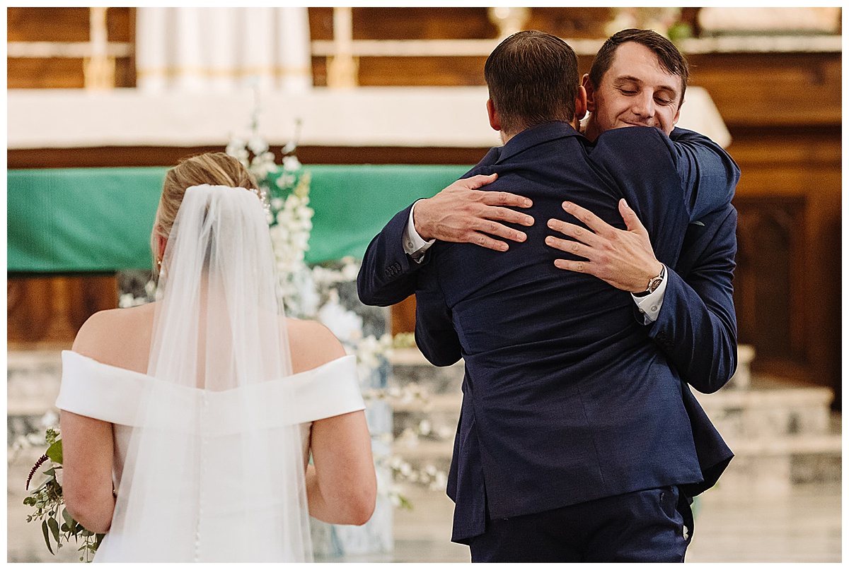 Father of the bride and groom share a hug for Detroit Wedding Photographer