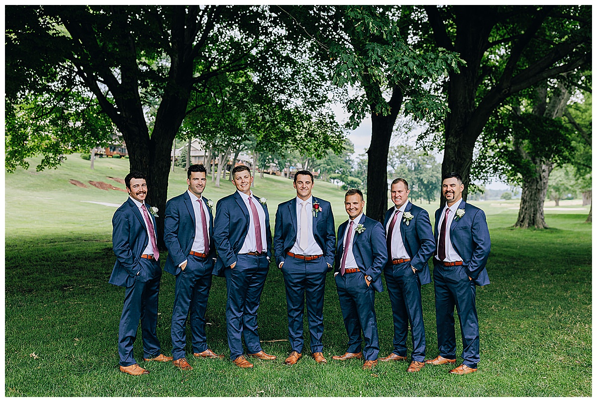 Groomsmen with hands in pockets by Kayla Bouren Photography