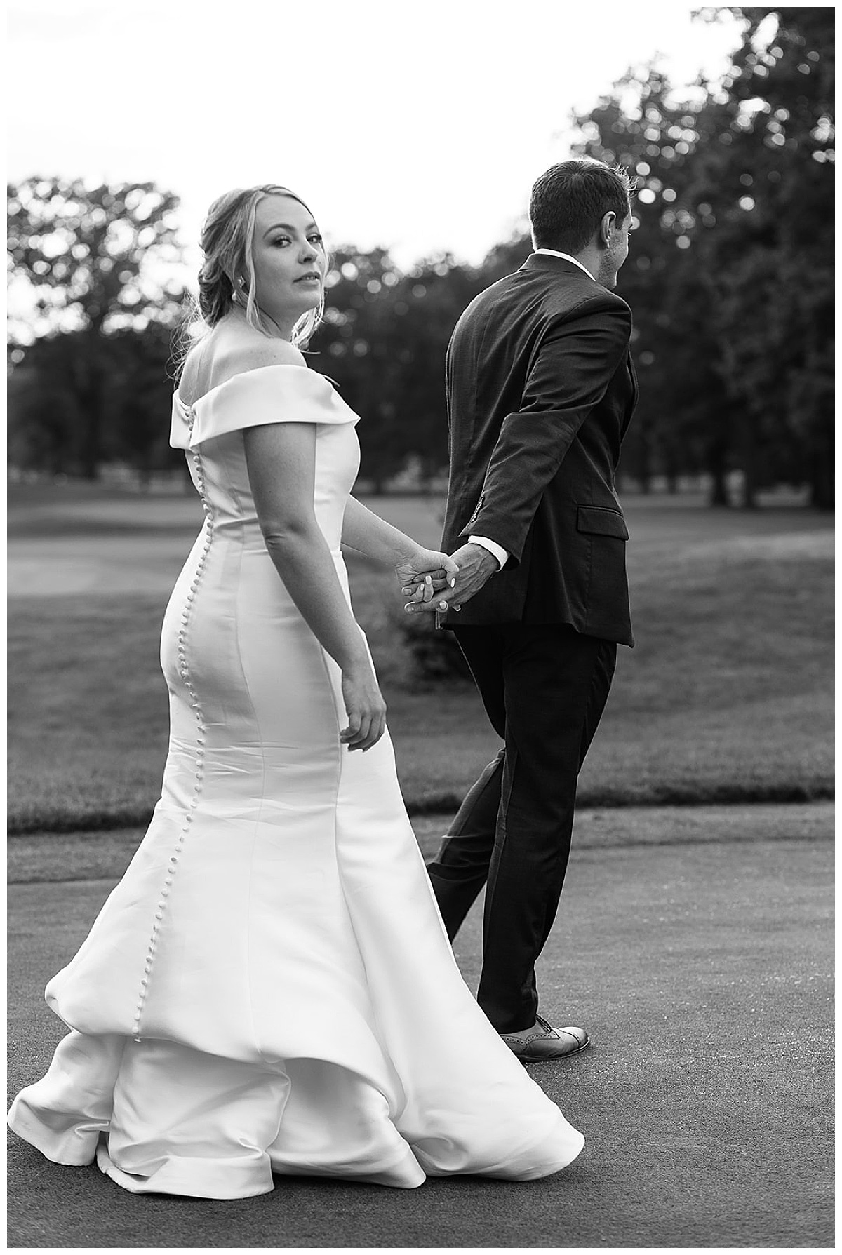 Groom leads bride at Toledo country club.