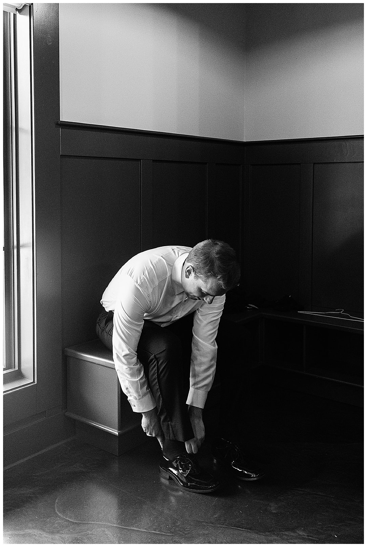 Groom adjusting shoes for Detroit Wedding Photographer