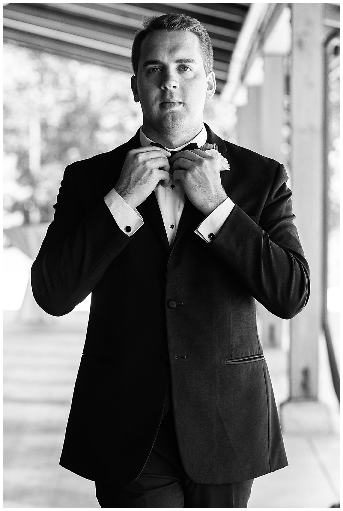 Groom adjust tie by Detroit Wedding Photographer