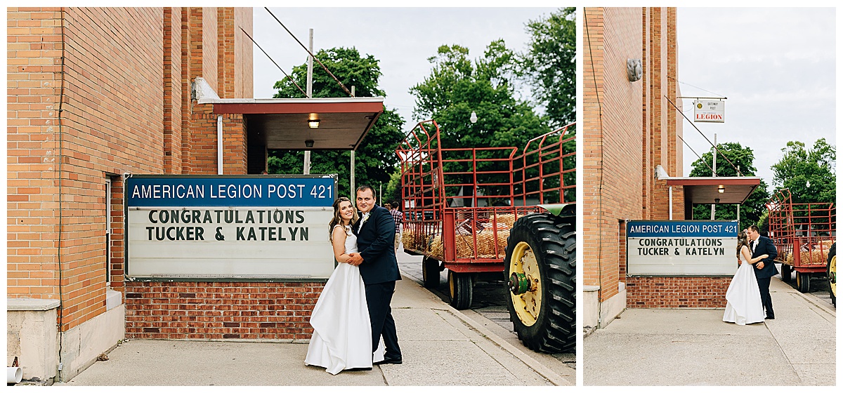 Husband and wife stand near sign for Detroit Wedding Photographer