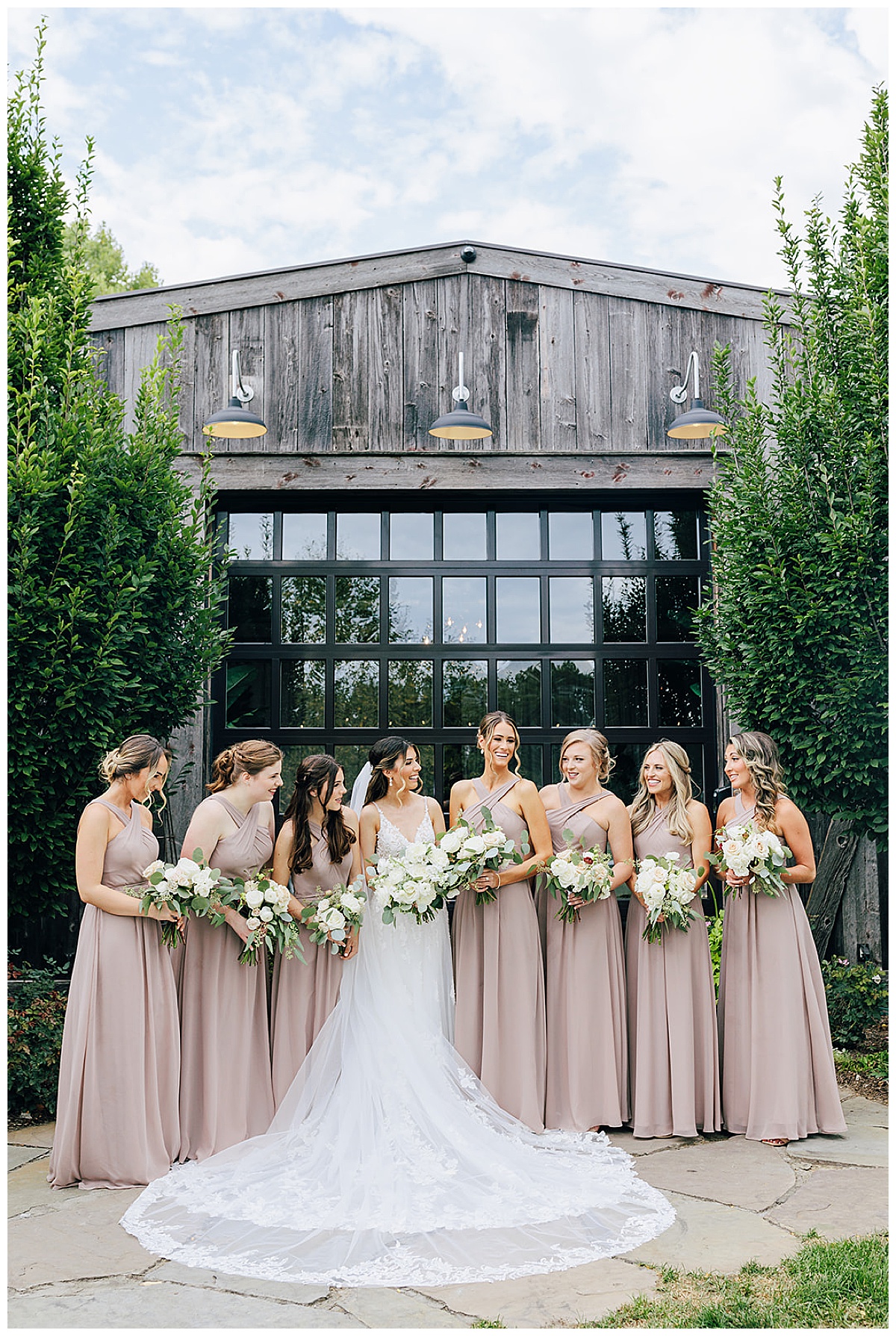 Bride surrounded by friends and family for Kayla Bouren Photography