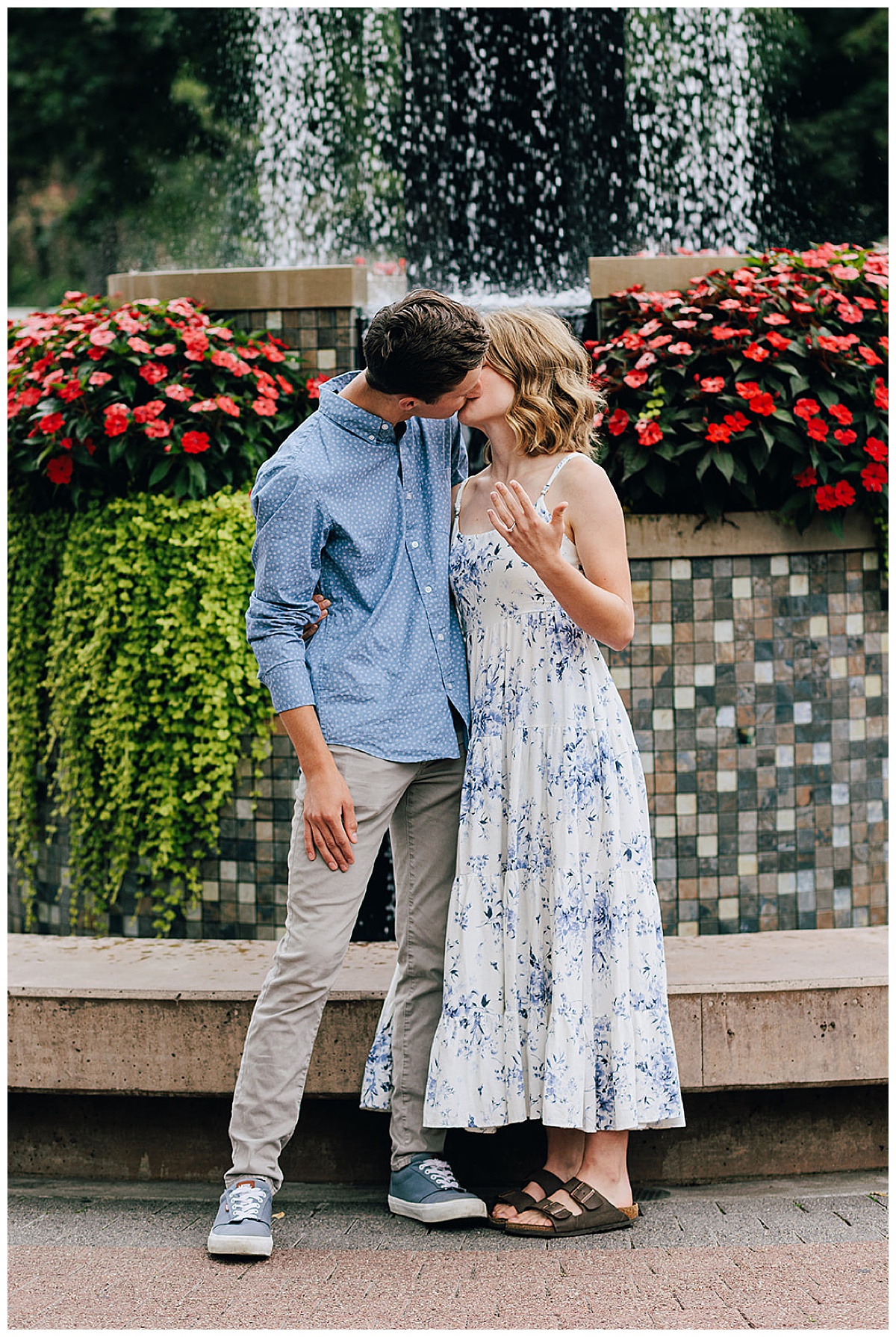 Engaged couple share a kiss after Zehnder’s Fountain Proposal