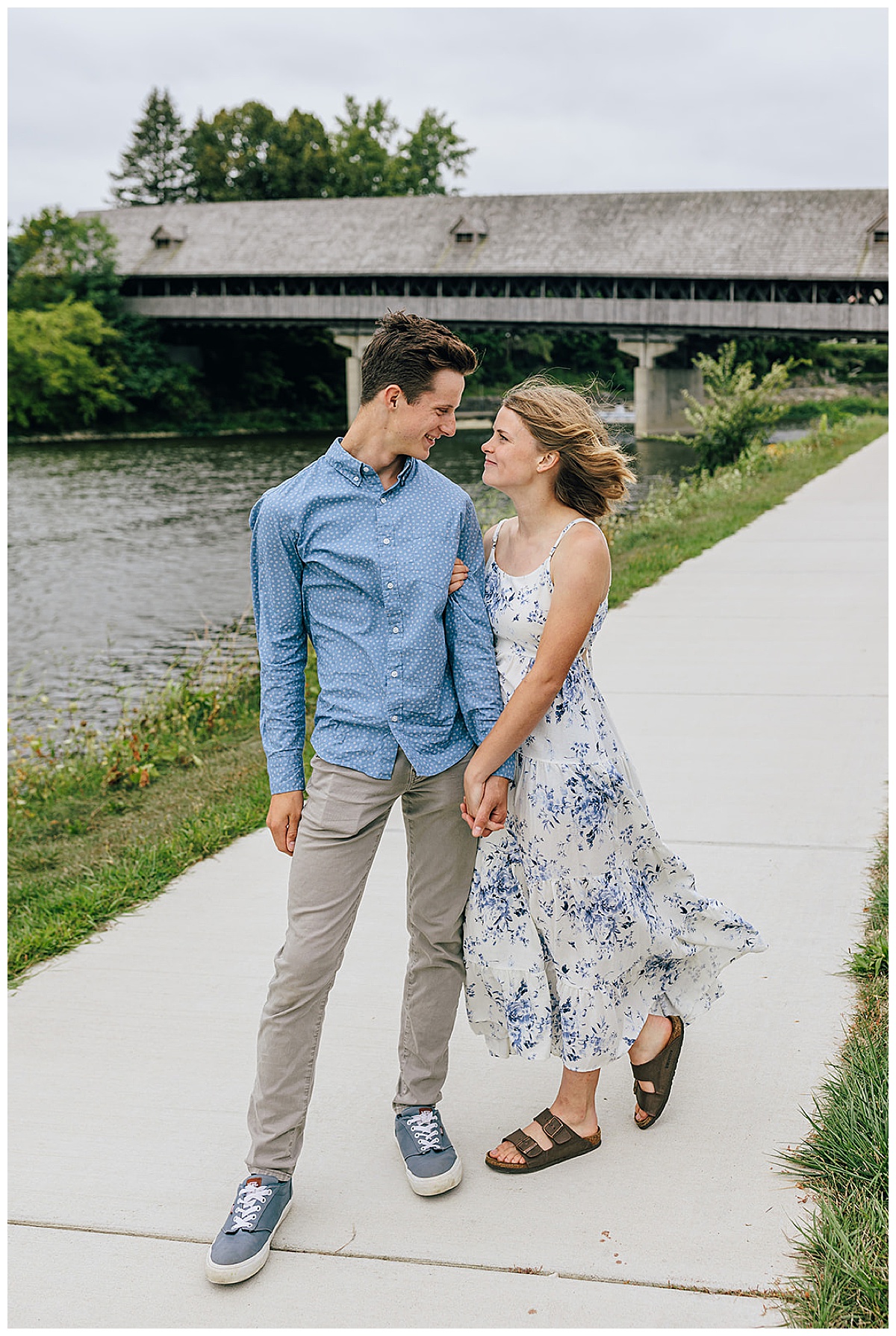 Engaged couple holding hands by water for Kayla Bouren Photography