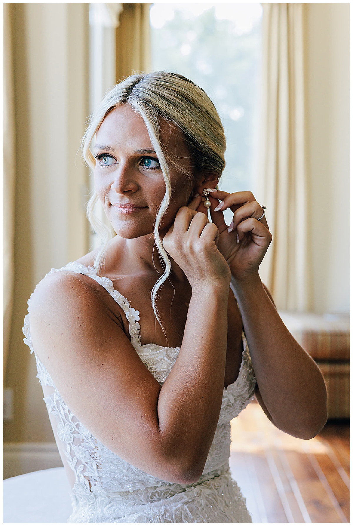 Woman adjusts bridal earrings for Kayla Bouren Photography