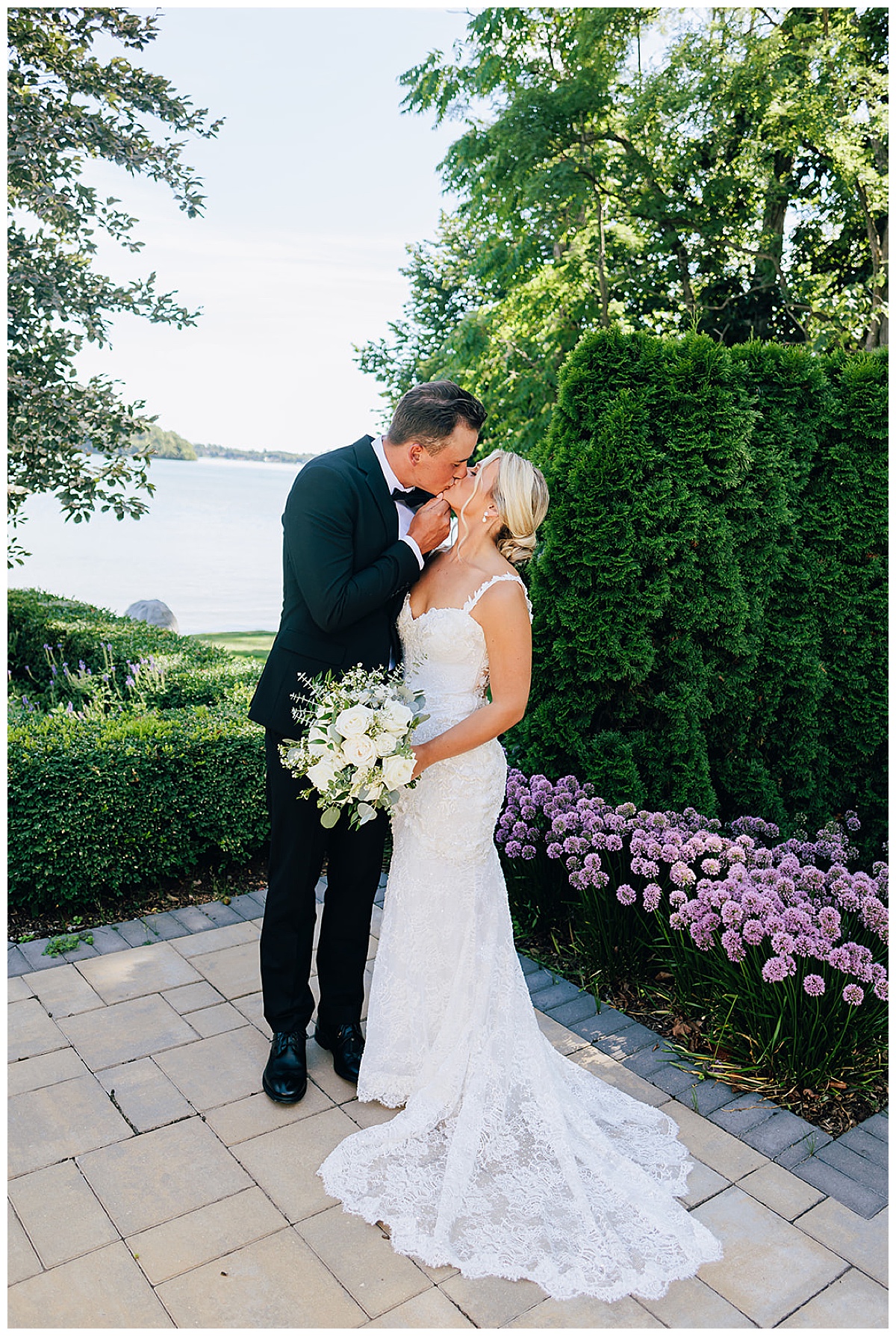 Groom kisses bride for Kayla Bouren Photography