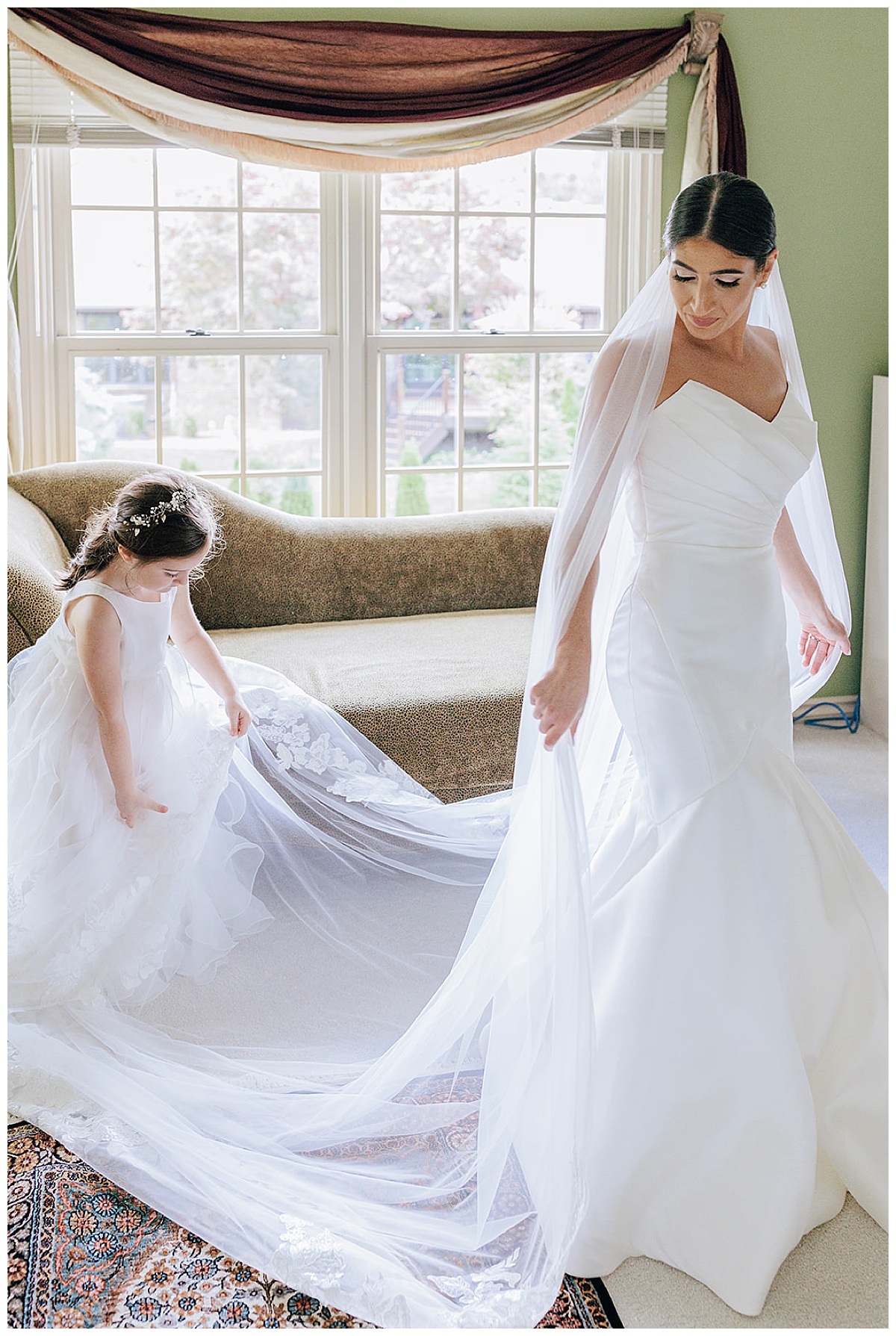Flower girl helps bride with dress for Detroit Wedding Photographer