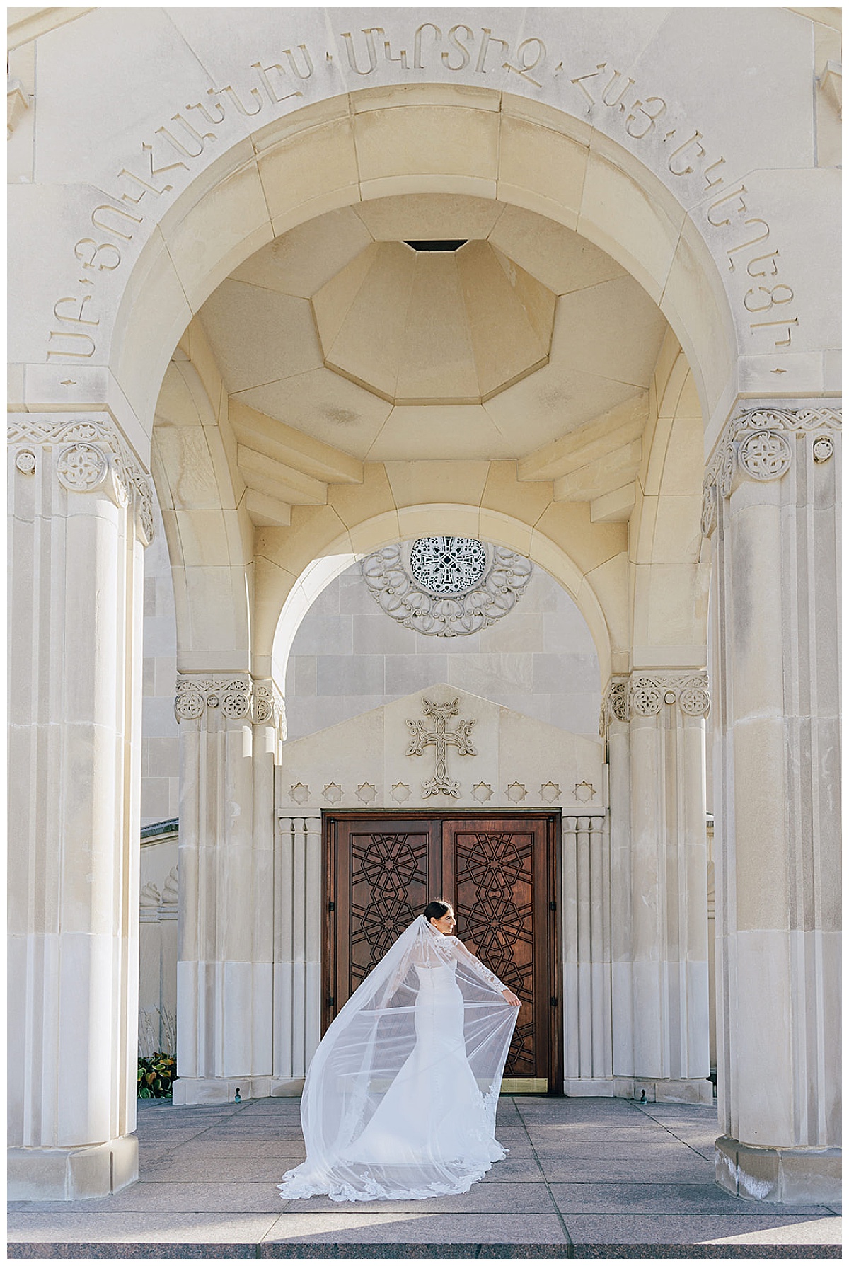 Bride stands in front of church doors for Detroit Wedding Photographer