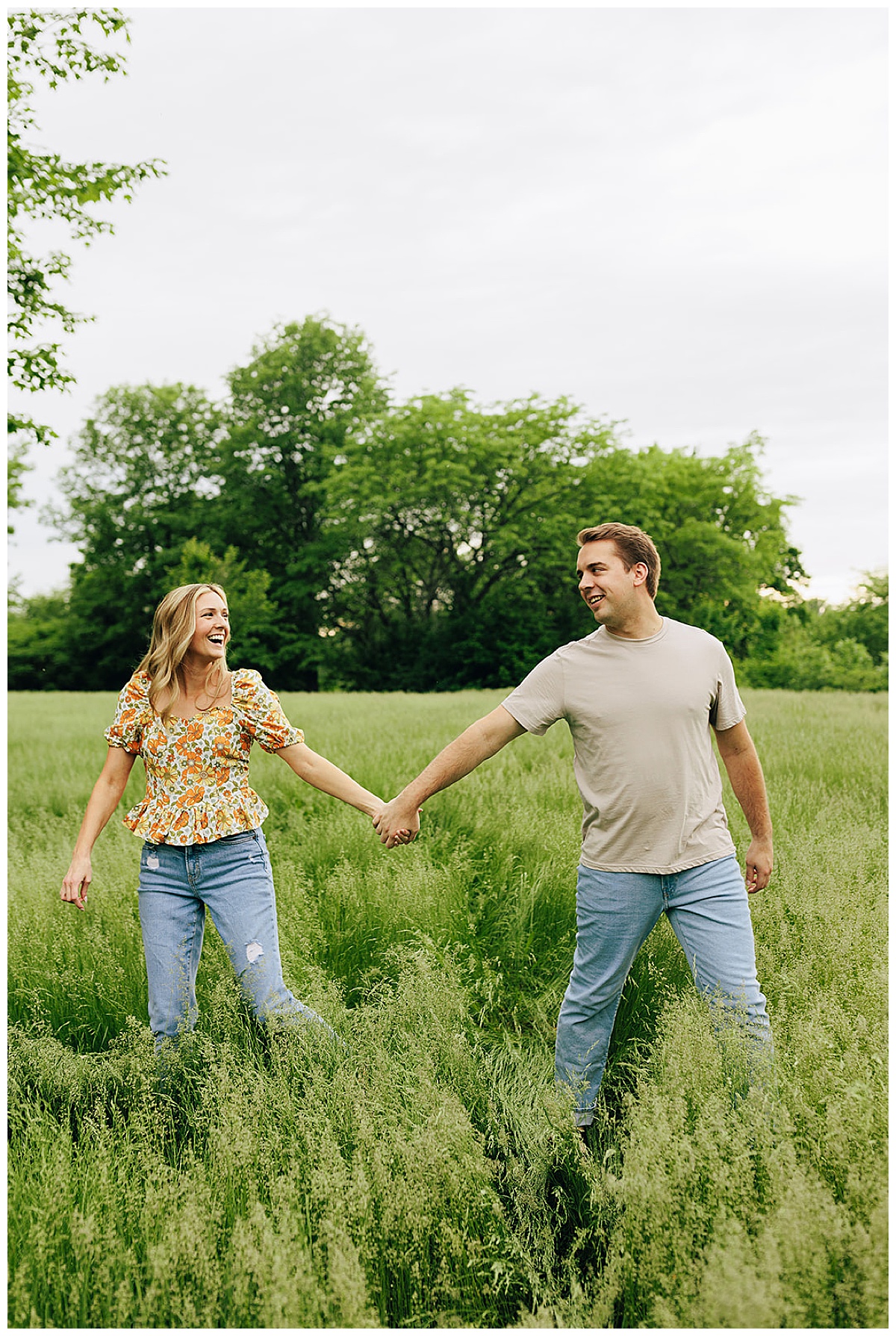 Couple walks in field for Detroit wedding photographer