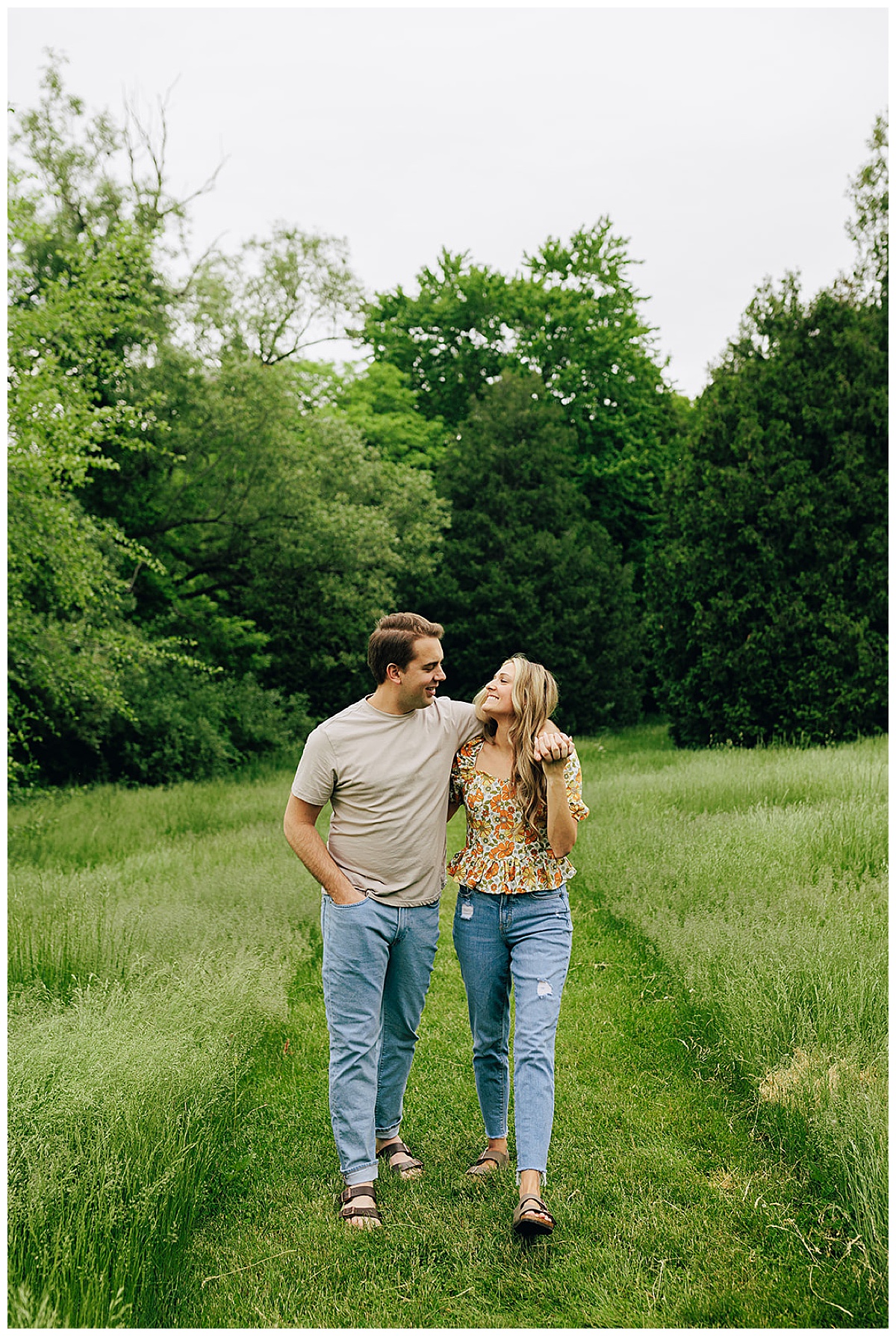 Man holds woman in grassy area for Kayla Bouren Photography