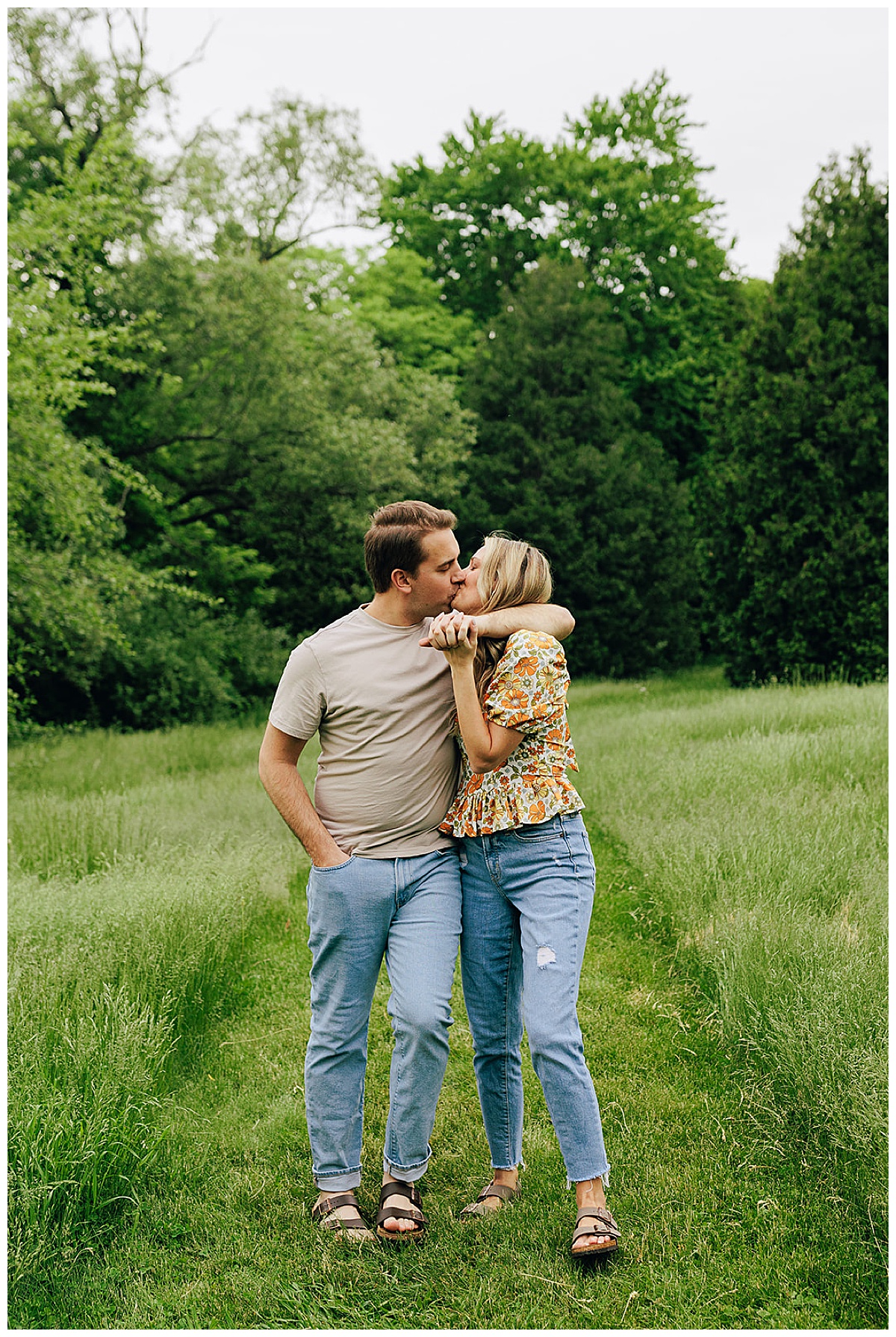 Two people kiss in field during Island Lake State Park Engagement Session