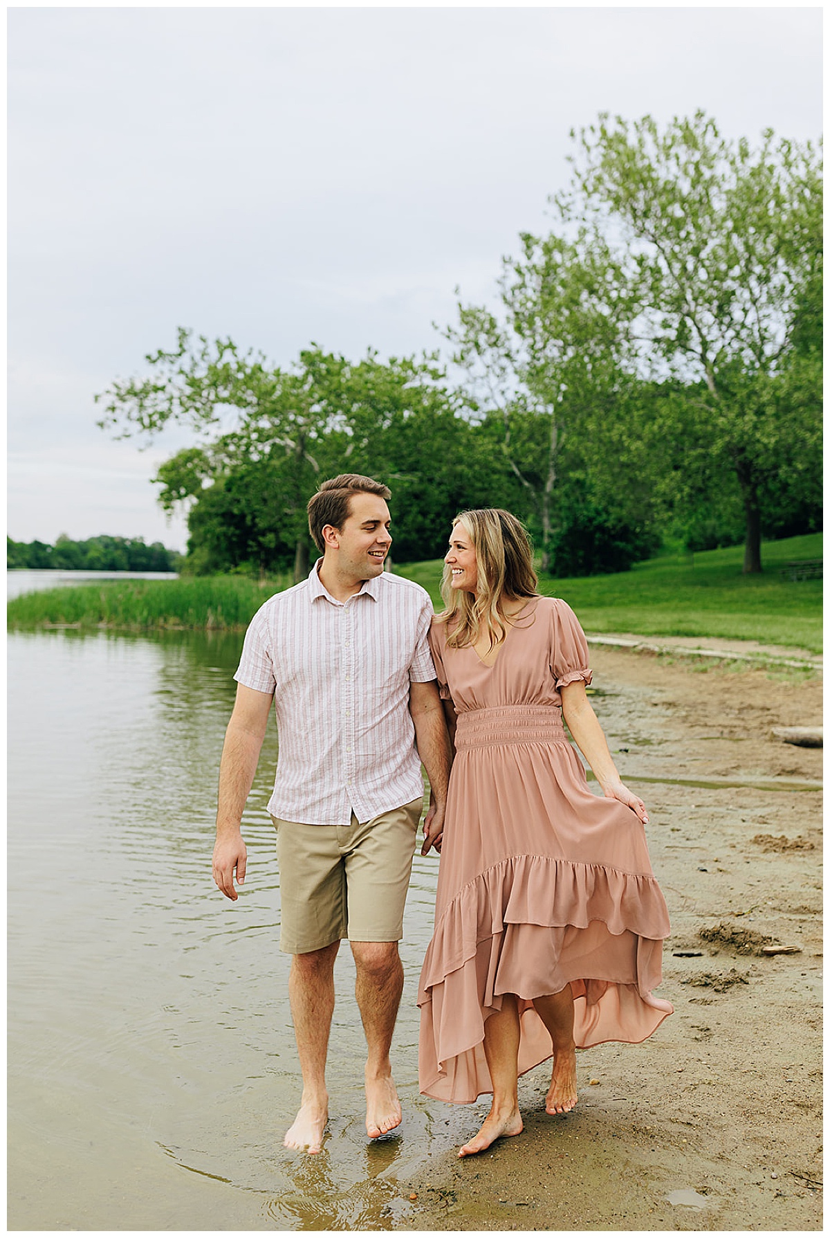 Couple walk together by lake for Detroit wedding photographer