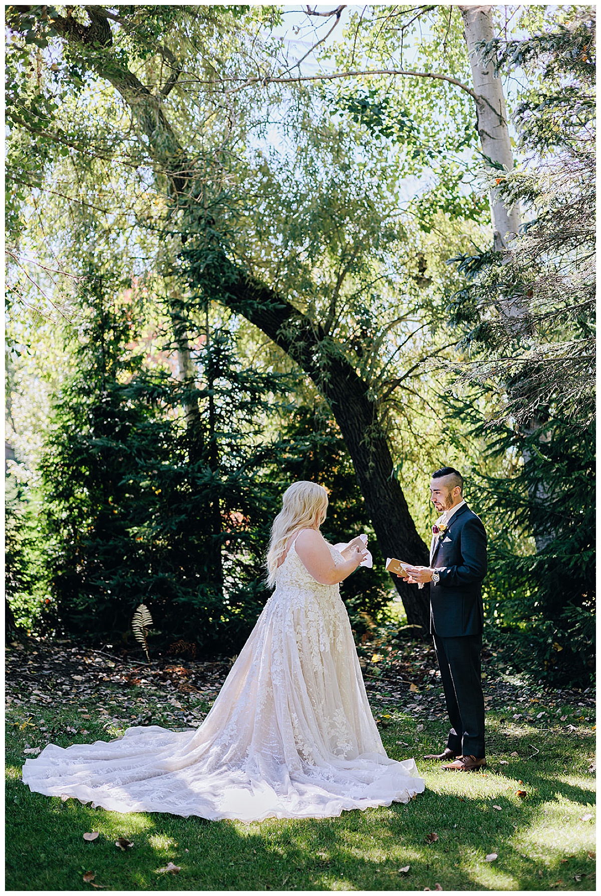 Man and woman stand under tree for Kayla Bouren Photography
