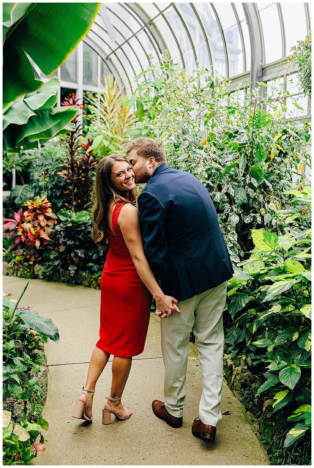 Man kisses woman at Anna Scripps Whitcomb Conservatory