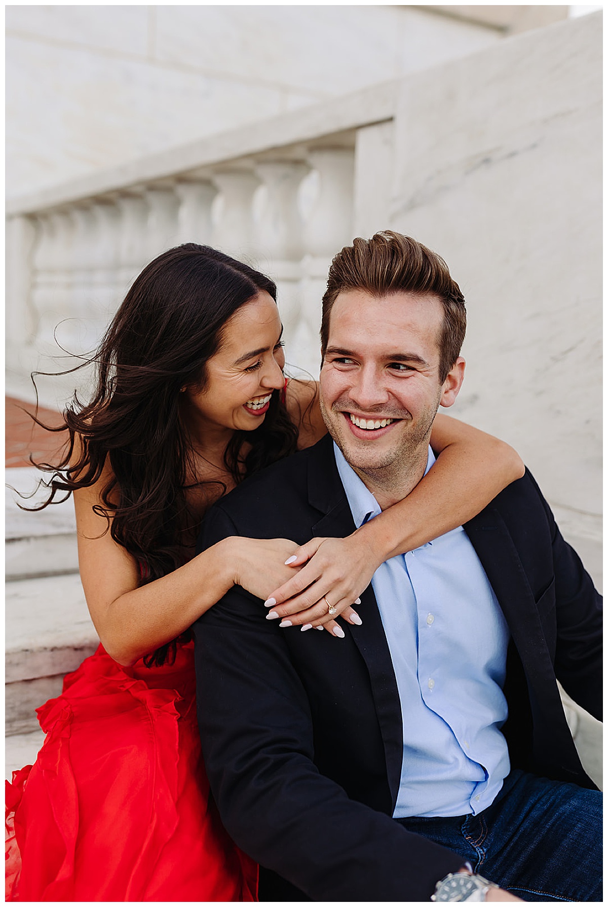 Future bride and groom laugh together on steps for Kayla Bouren Photography