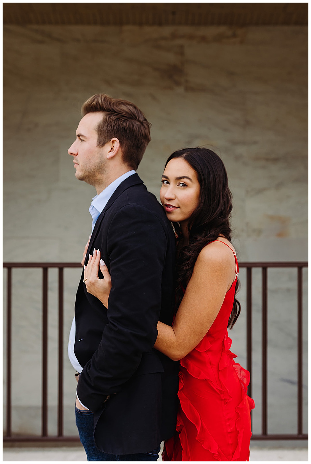 Woman in red dress hugging man for  DIA Engagement Session