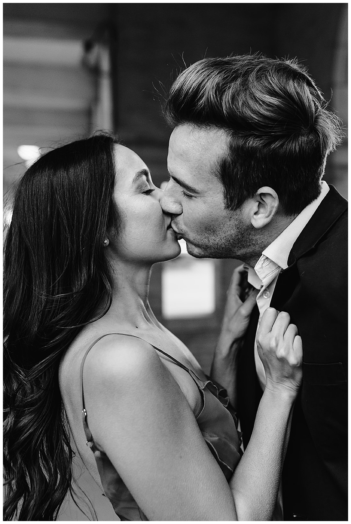 Man and woman share a kiss for DIA Engagement Session