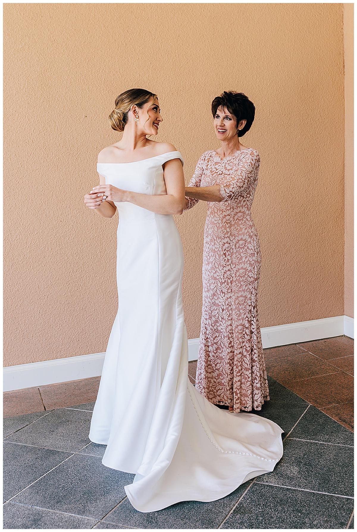 Mother helps bride with dress for Detroit Wedding Photographer