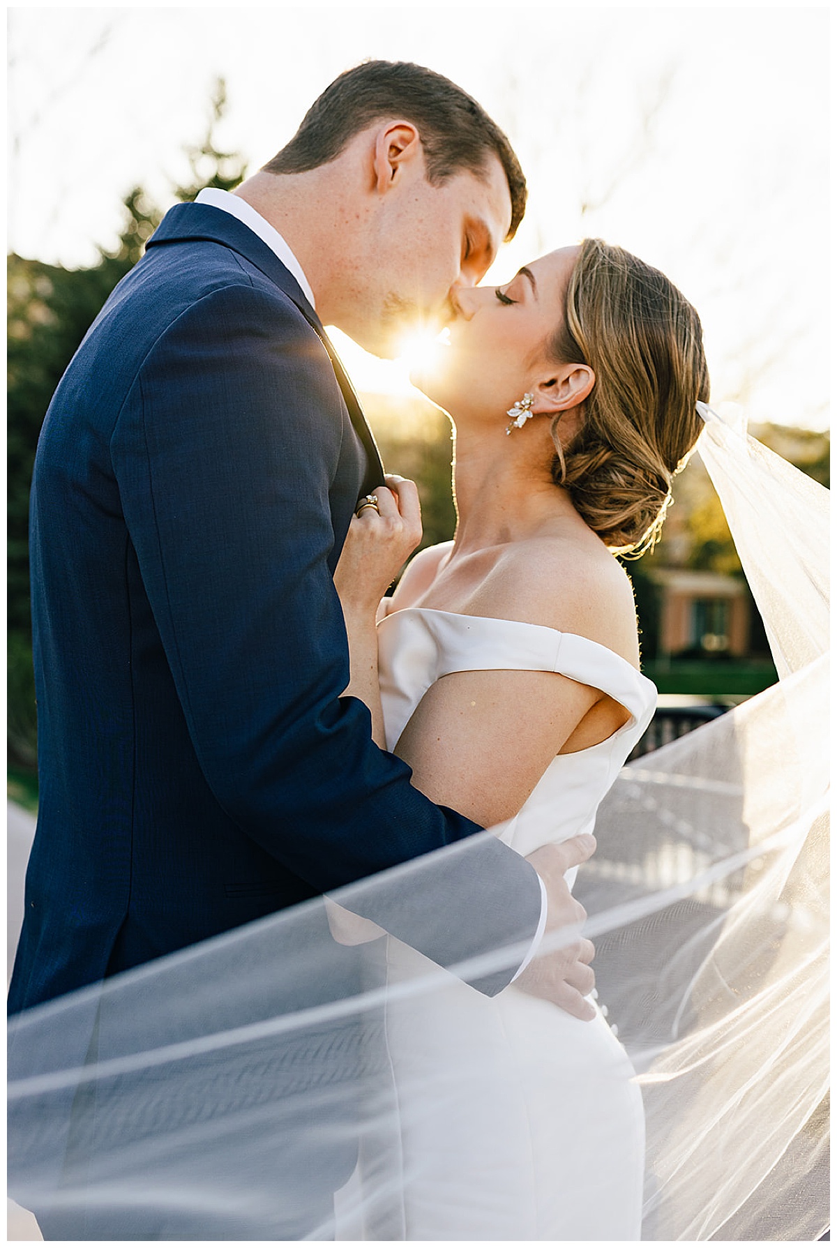 Couple kiss in the sunlight for luxury Colorado wedding