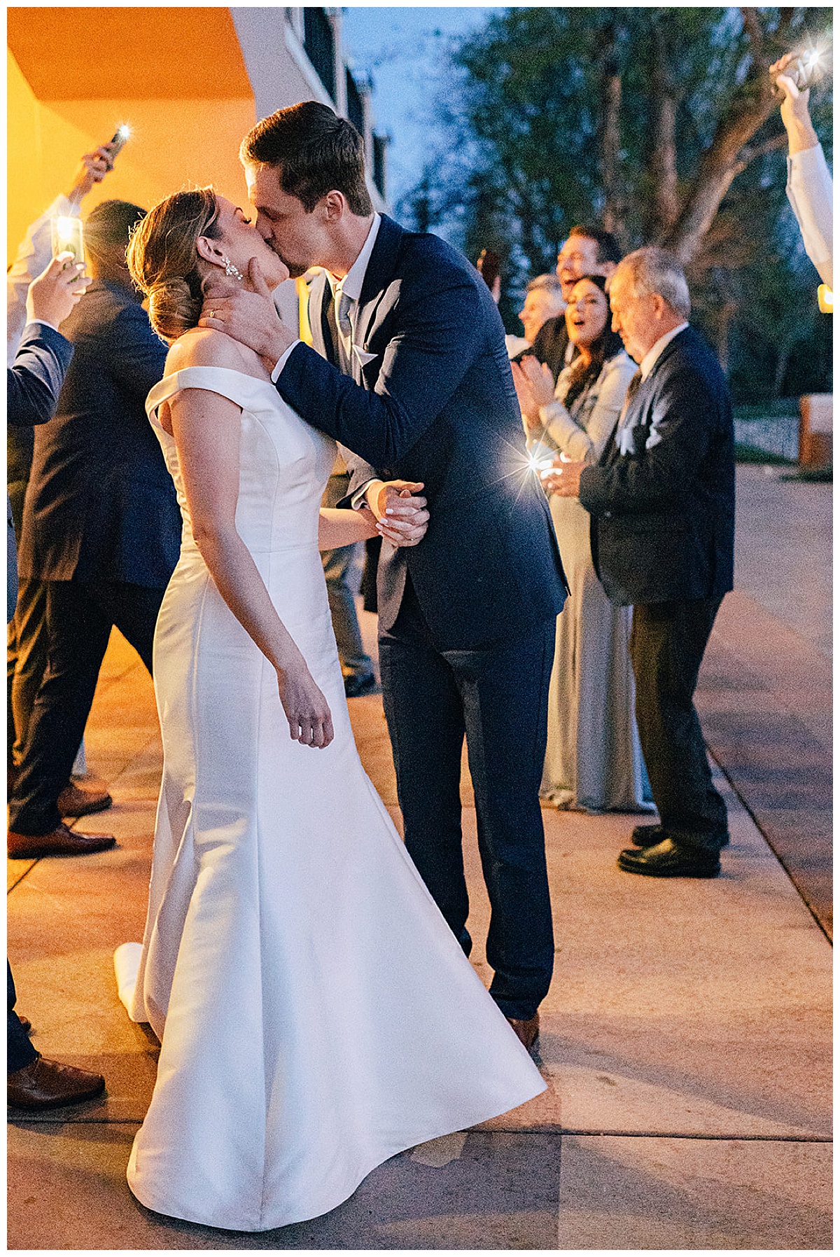 Couples kisses as they leave their luxury Colorado wedding