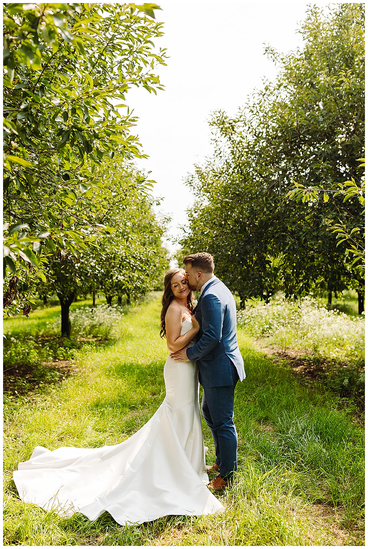 Couple kiss in fields for Kayla Bouren Photography