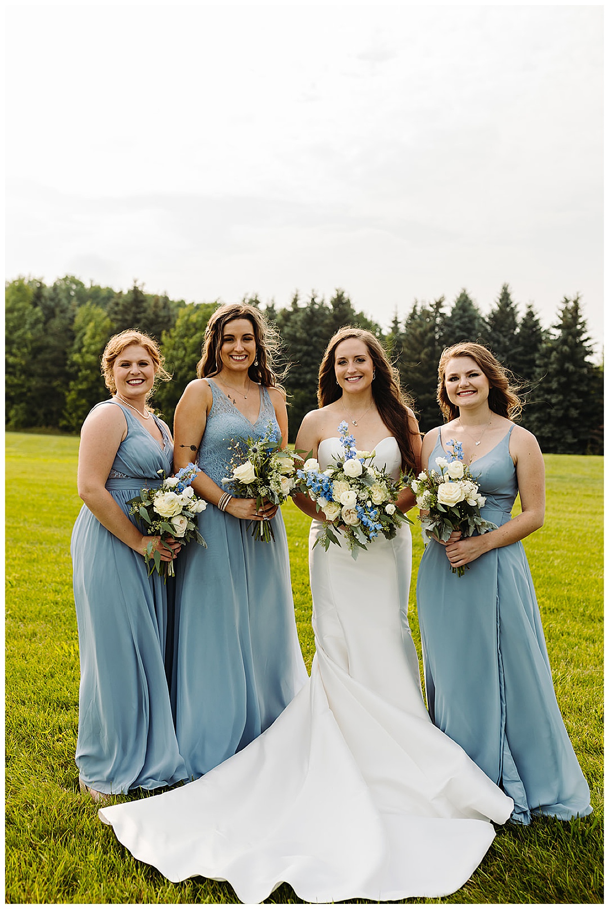 Bridesmaids stand with bride for Kayla Bouren Photography
