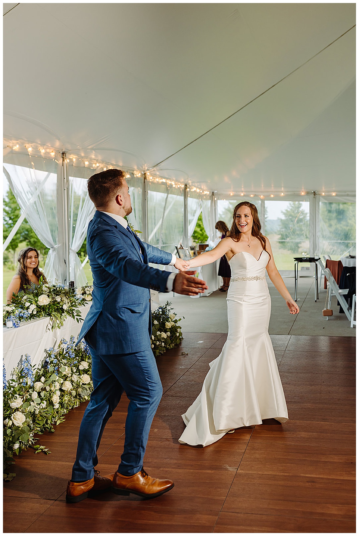 Woman smiles at man while dancing for Detroit Wedding Photographer
