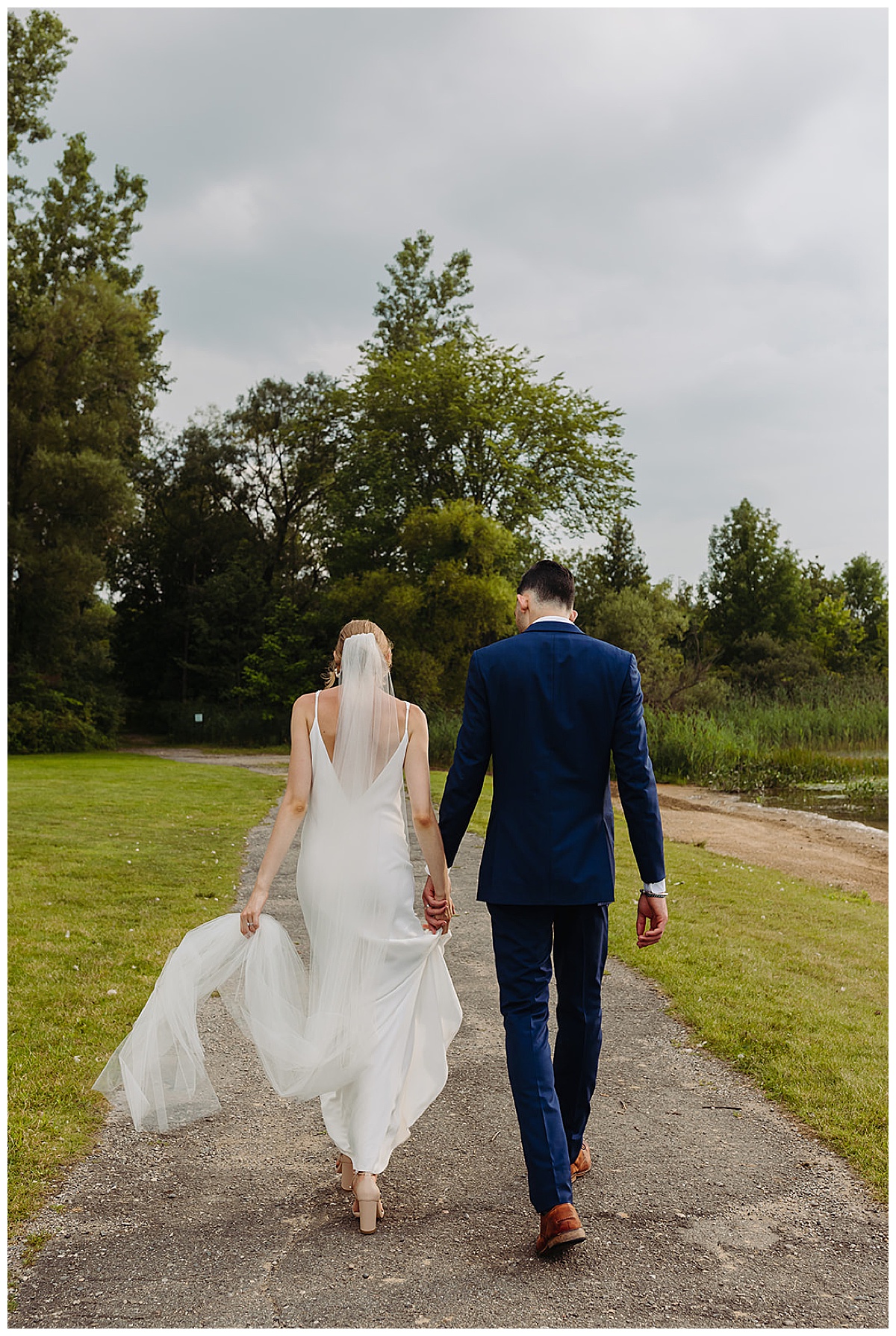 Couple walk hand in hand together for Kayla Bouren Photography