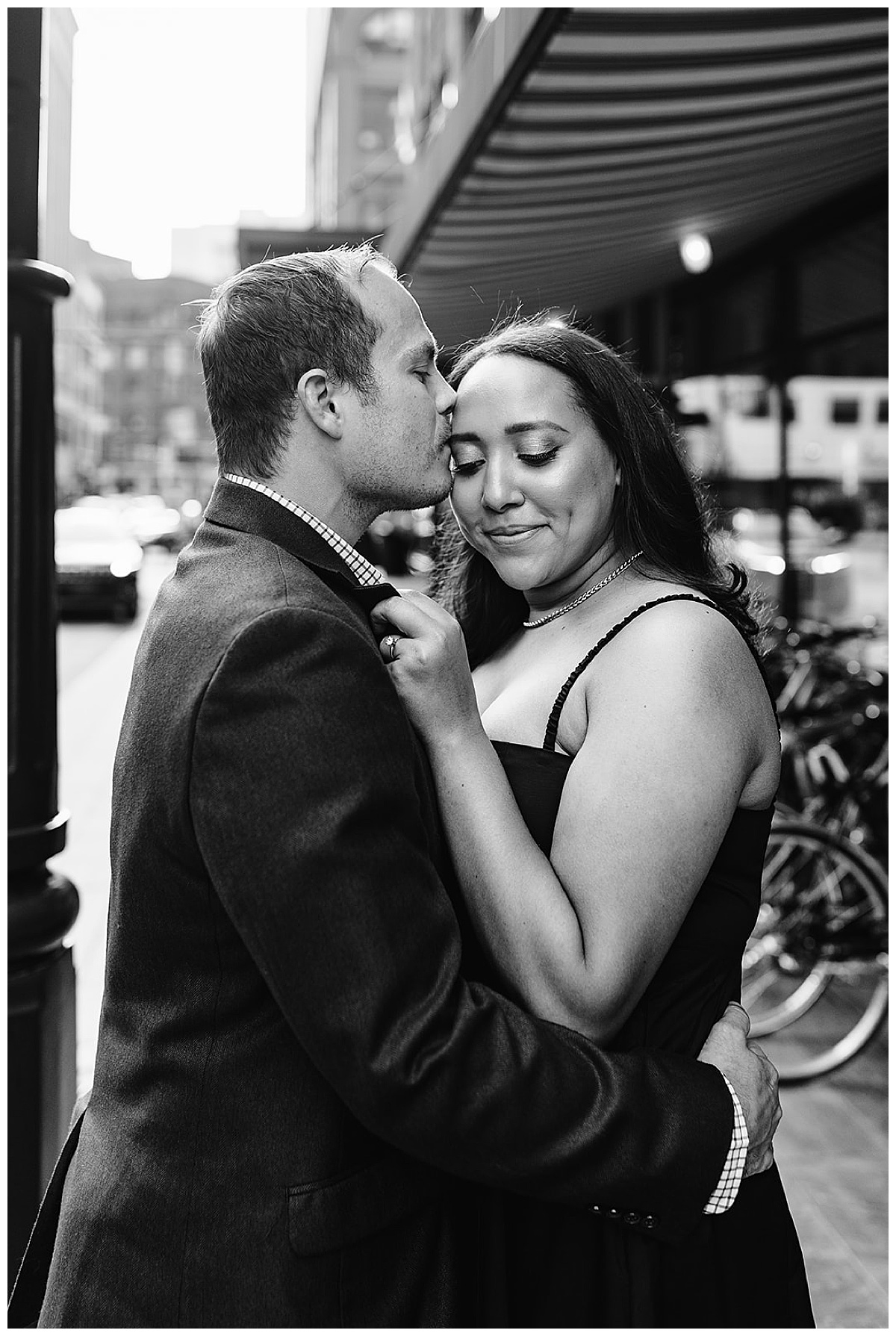 Man kisses woman on forehead for Kayla Bouren Photography