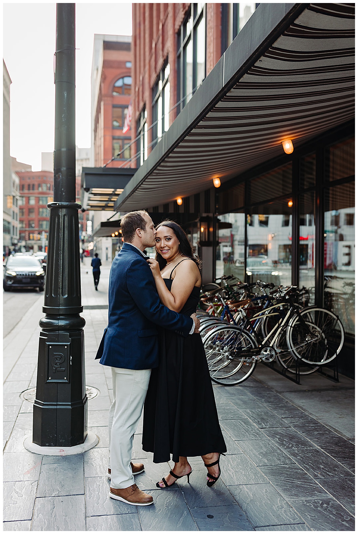 Woman holds guy in close for Woodward Ave. engagement session