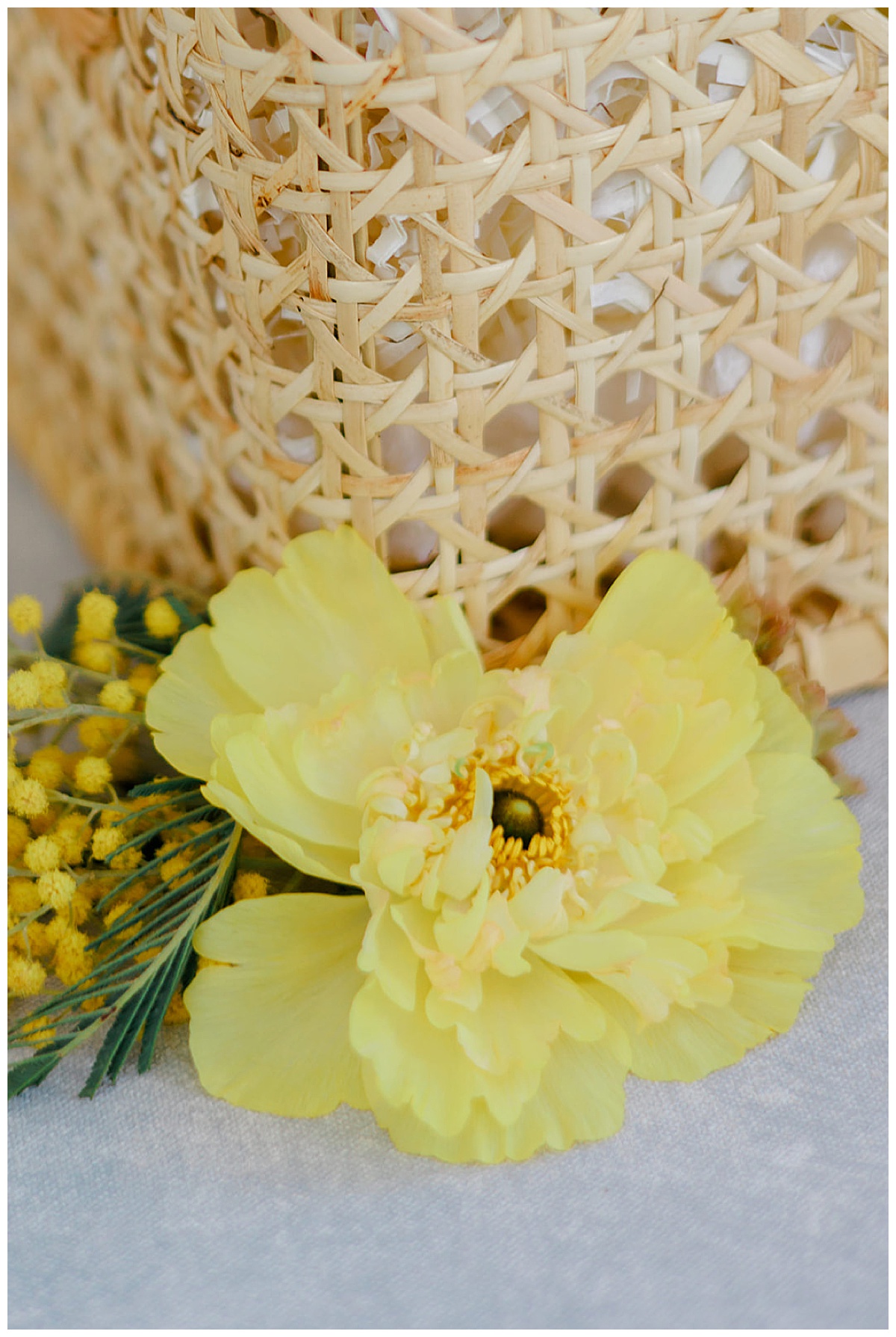 Stunning yellow flower next to wicker basket for Detroit Wedding Photographer