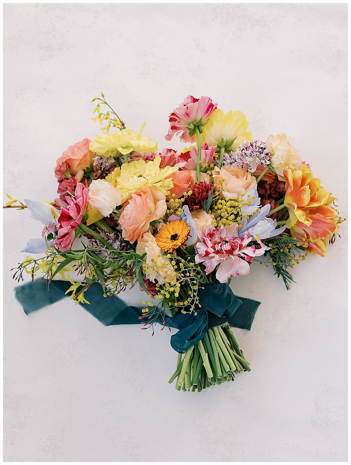 Stunning orange and pink toned floral bouquet for Detroit Wedding Photographer