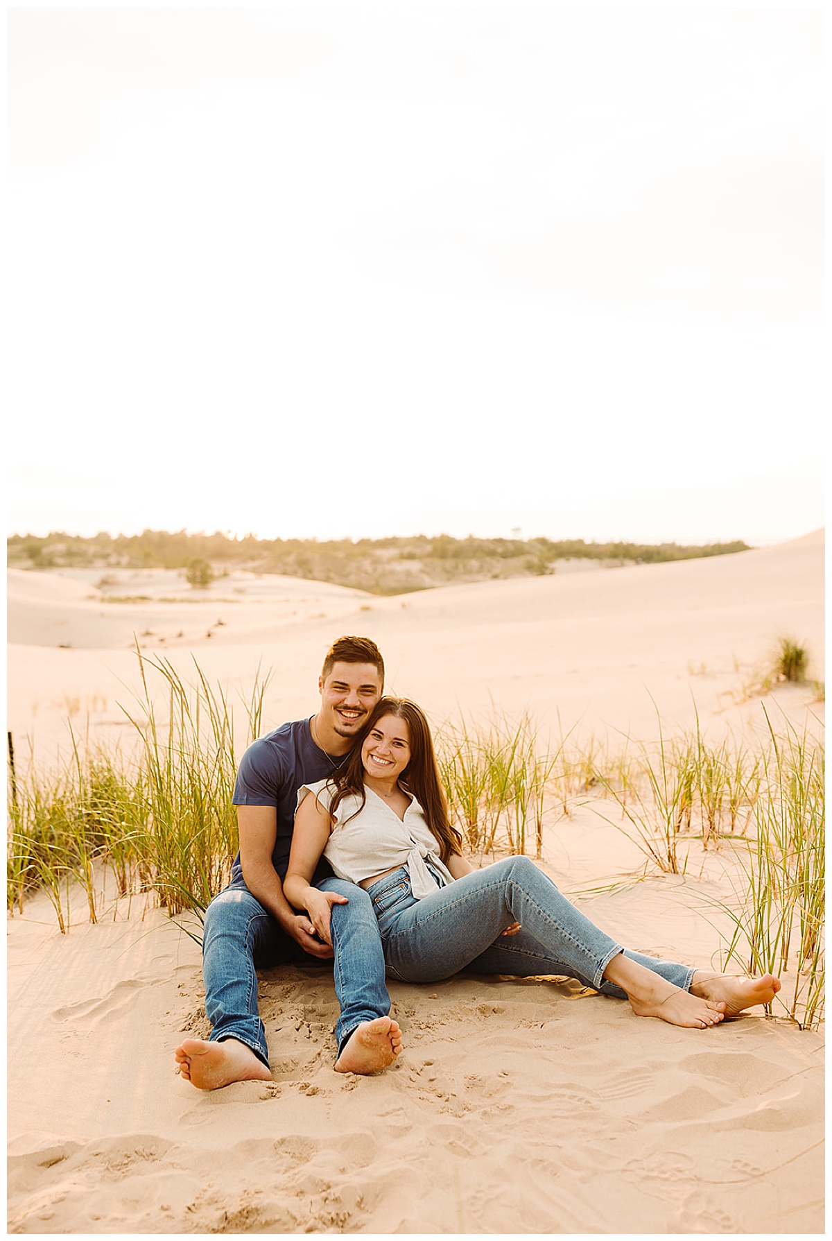 Couple sit together in sand for Detroit Wedding Photographer