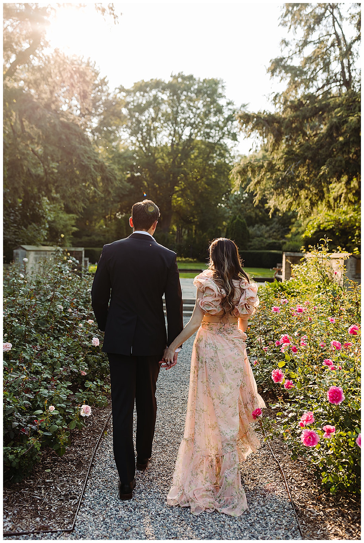 Fiances hold hands through garden for Detroit Wedding Photographer