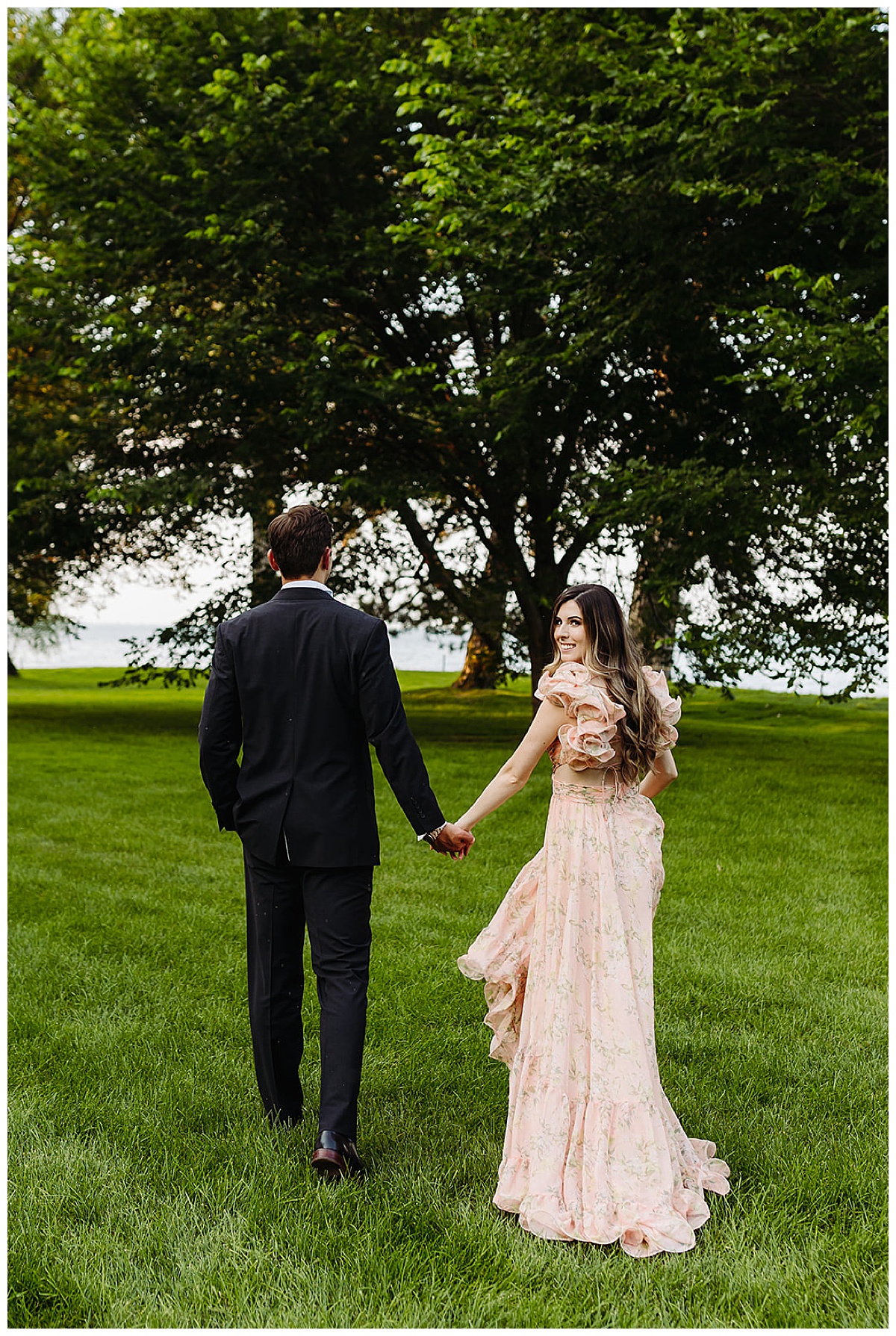 Husband and wife hold hands and walk together for Kayla Bouren Photography