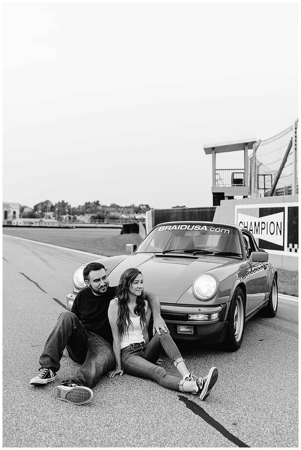Two people sit in front of car for Kayla Bouren Photography