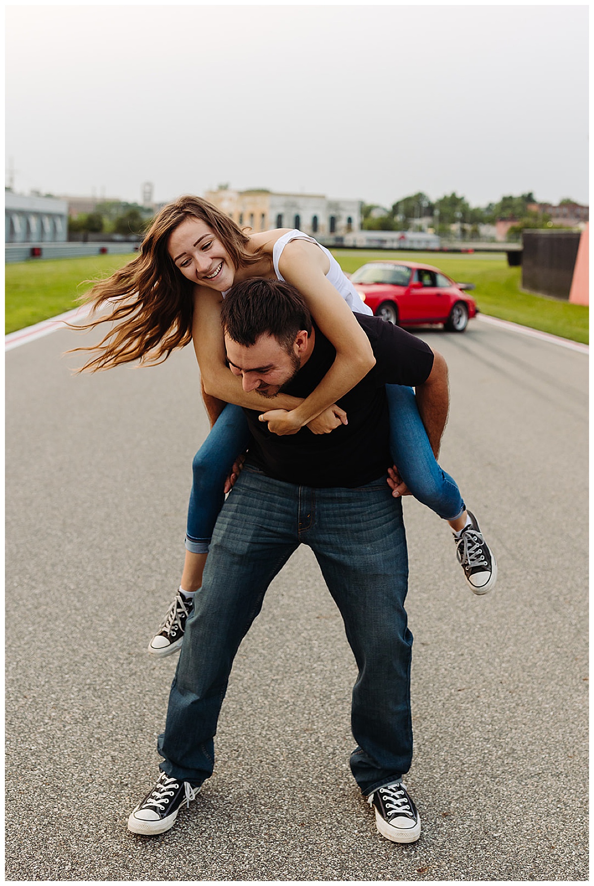Guy gives woman piggy back ride for Kayla Bouren Photography