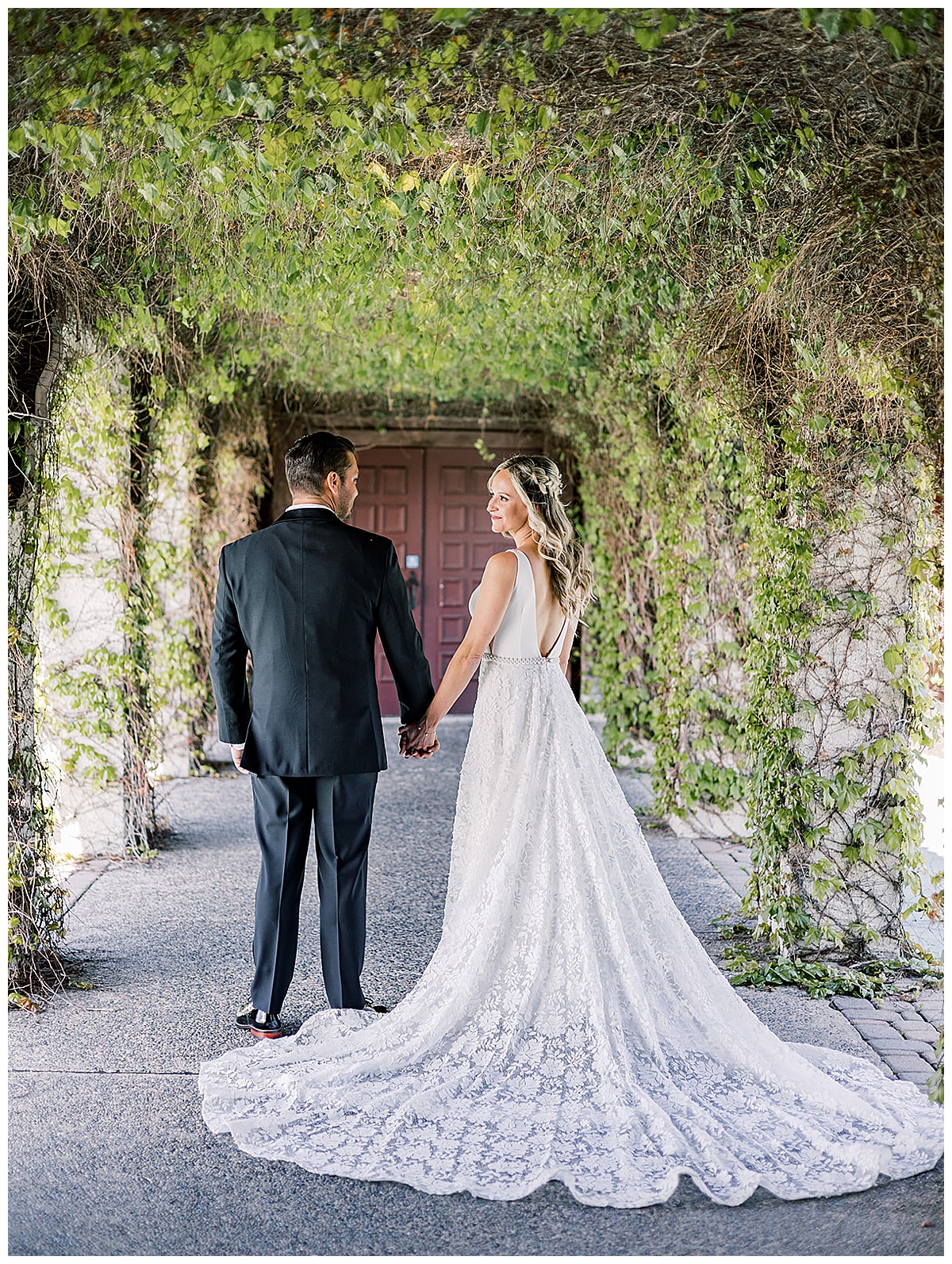 Stunning couple stand hand in hand in wedding attire for Kayla Bouren Photography