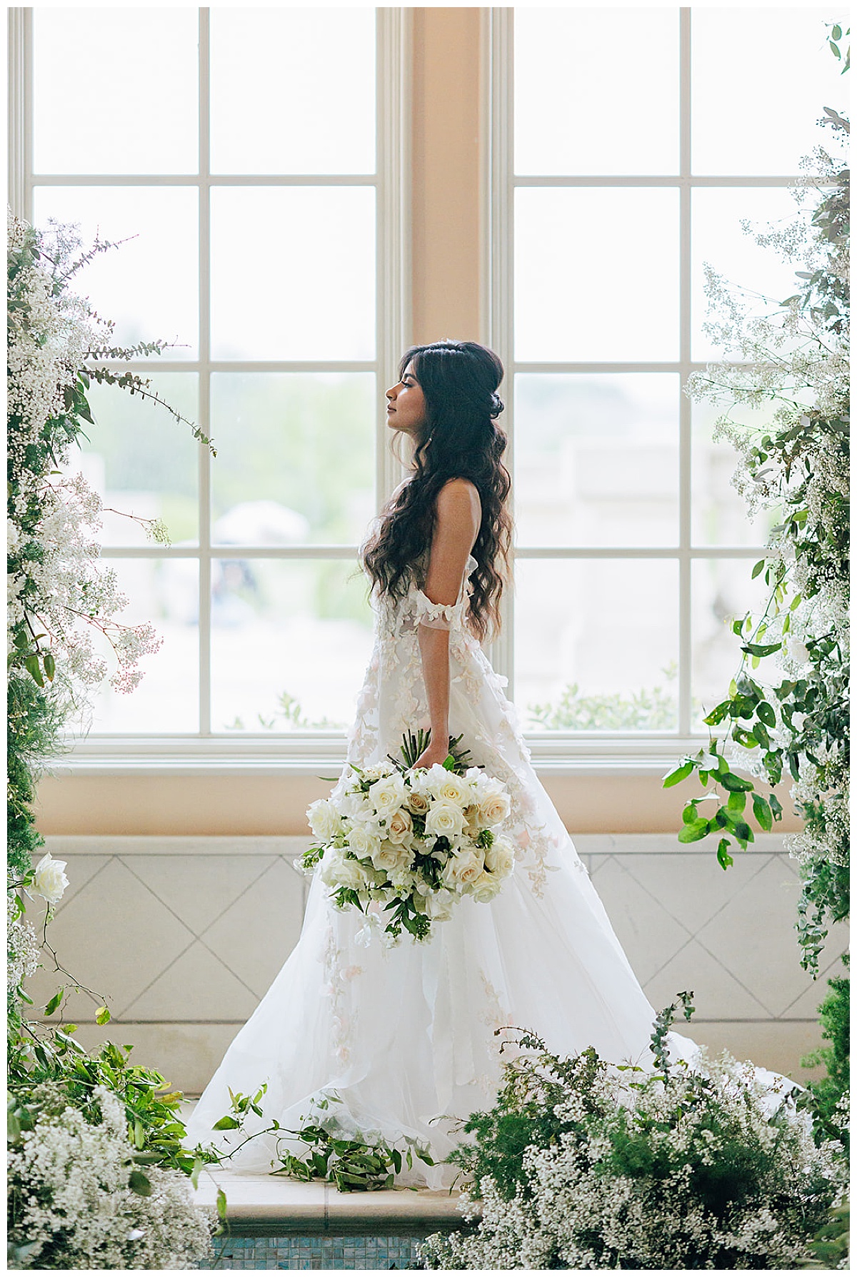 Stunning bride holds bouquet by side for Kayla Bouren Photography
