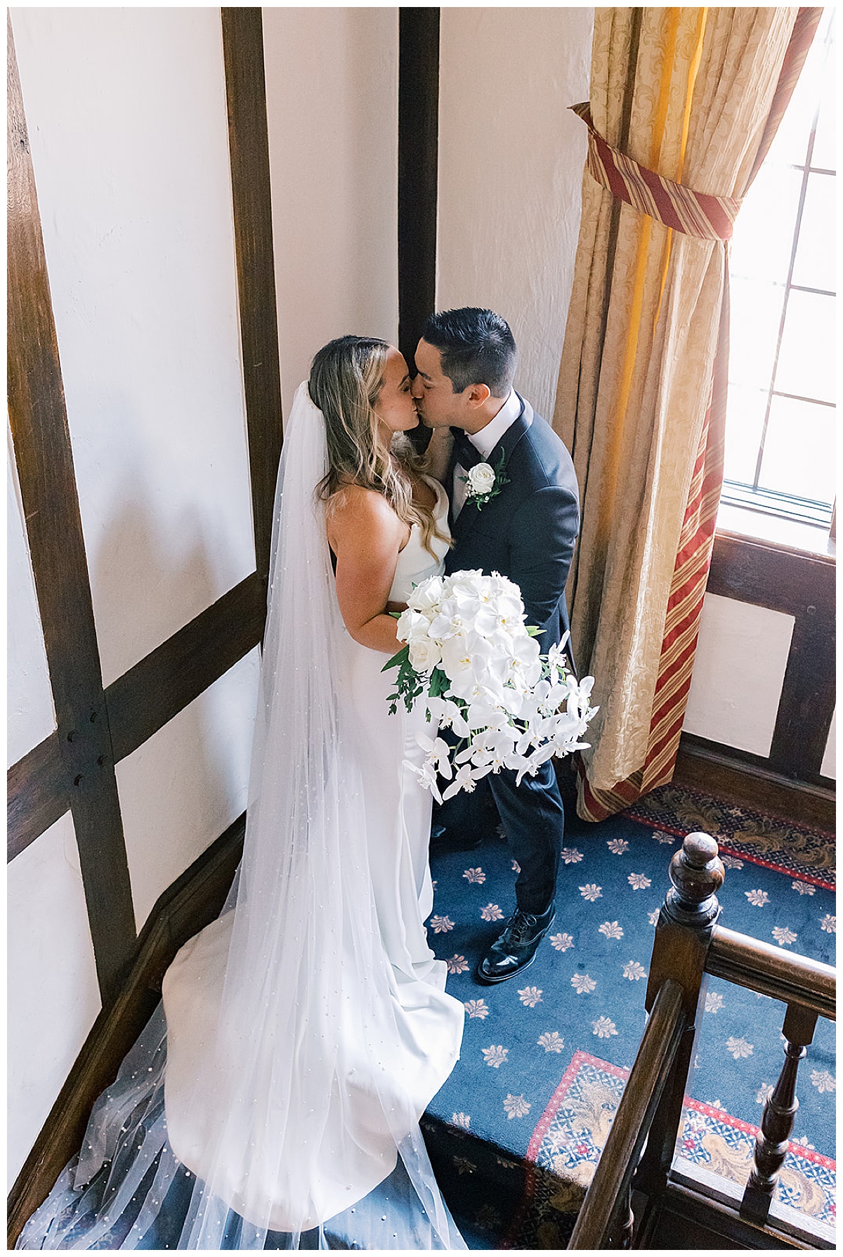 Bride and groom share a kiss in the stairwell for Meadowbrook Country Club